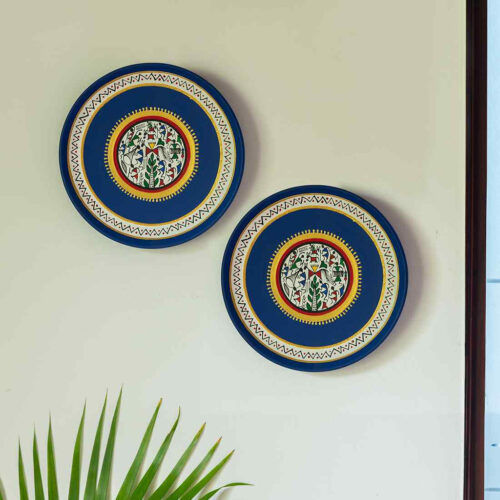 'The Warli Tales' Hand-painted Terracotta Wall Plates Wall Decor (20.3 cm, Set of 2, Blue) 'The Warli Tales' Hand-painted Terracotta Wall Plates Wall Decor (20.3 cm, Set of 2, Blue)